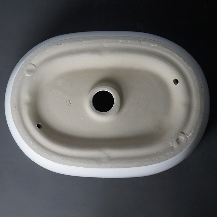 Lavabo moderno ovale in ceramica artistica sopra il lavandino del bagno da appoggio